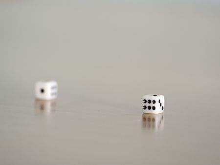 dice reflected on a brown wooden table