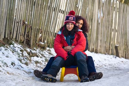 Two women on sledの写真素材