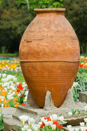 Huge vintage vase between tulips in a parkの写真素材