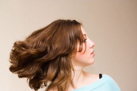 Portrait of a beautiful girl waving her hair, isolatedの写真素材