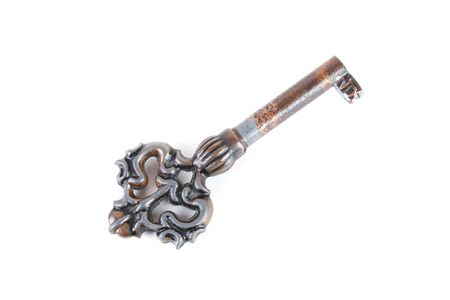 Close up of an old rusty key isolated on white backgroundの写真素材