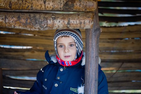 Cute 7 year old kid playing in a small wooden houseの写真素材