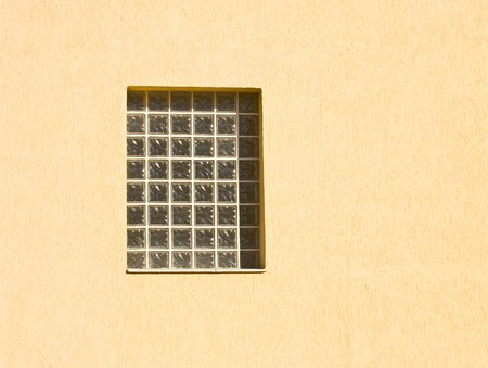 One window on a yellow wall outside
