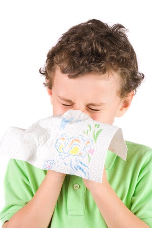 Close-up portrait of a child wiping his noseの写真素材