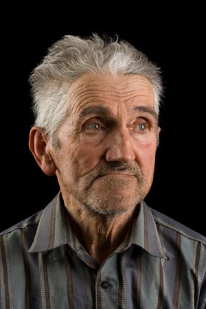 Portrait of an old man isolated on blackの写真素材