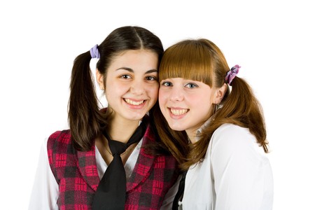 Two schoolgirls friends isolated on white backgroundの写真素材