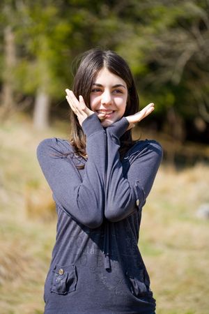 Portrait of a beautiful brunette girl outdoorsの写真素材