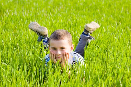 Portrait of a cute kid in a wheat fieldの写真素材