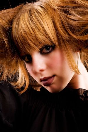 Portrait of a gothic young lady isolated on dark background