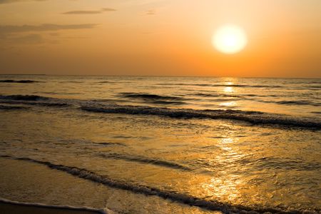 Sunrise with beautiful colors at the sea shoreの写真素材