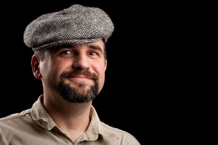 Close up portrait of a young man with grey hat, isolated on black background