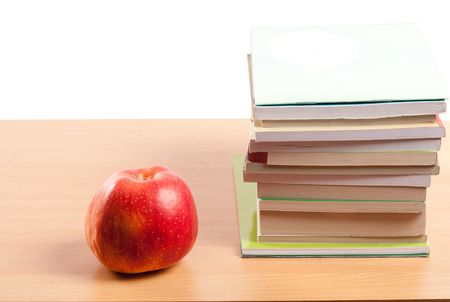 Red apple and books on a desk, isolated on whiteの写真素材