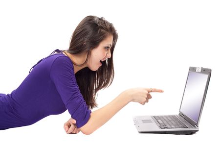 Portrait of a relaxed brunette using a laptop isolated on whiteの写真素材