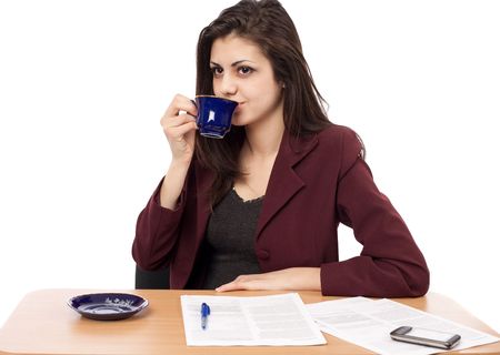 Young businesswoman having a coffee break isolated on whiteの写真素材