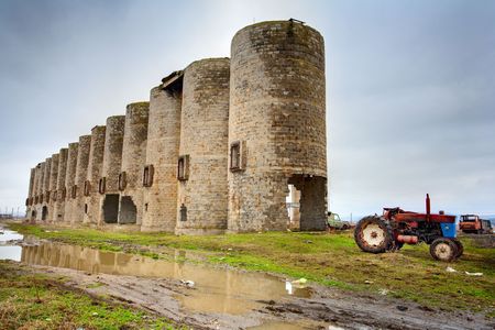 Abandoned facility under moody cloudy dark sky, image of decrepitudeの写真素材