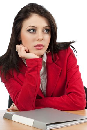 Worried young businesswoman with a folder on her deskの写真素材