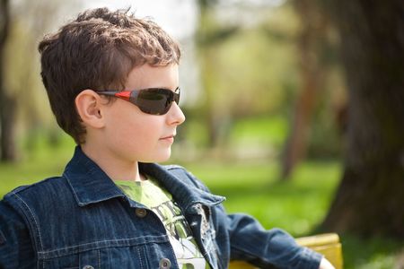 Closeup portrait of a trendy little boy outdoorの写真素材