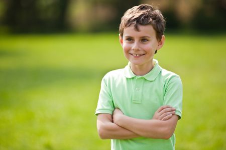 Portrait of a beautiful little boy outdoor in a parkの写真素材