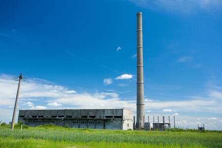 Landscape with abandoned industrial facilities under blue skyの写真素材