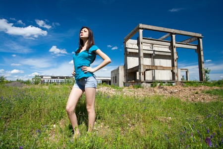 Portrait of a beautiful young woman in an industrial backgroundの写真素材