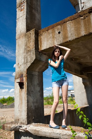 Portrait of a beautiful young woman in an industrial backgroundの写真素材
