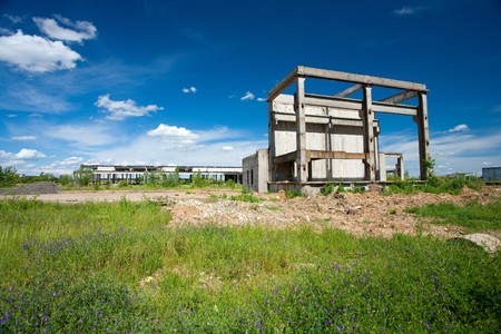 Landscape with abandoned industrial facilities under blue skyの写真素材