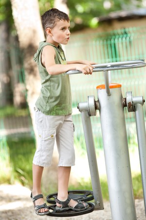 Kid with cool haircut doing fitness outdoor and having funの写真素材