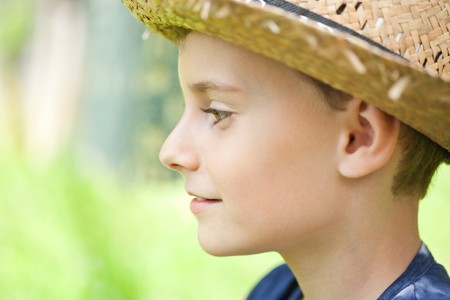 Close up portrait of a country boy with a straw hatの写真素材