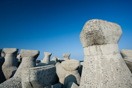 Landscape with breakwater dam rocks and blue skyの写真素材