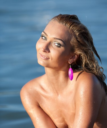 Portrait of a young lady in sea waterの写真素材