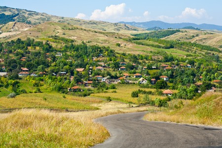 Alpine landscape with a road going to a villageの写真素材