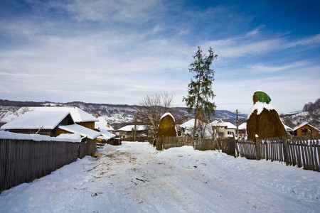 Landscape with Romanian traditional village in a winter dayの写真素材