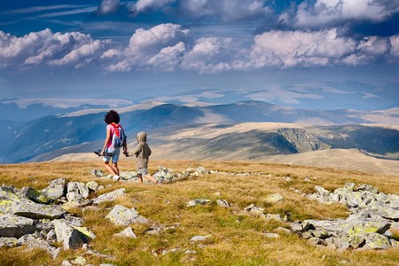 Mother and son having a great time together, traveling in the mountains