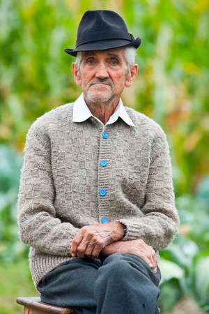 Portrait of a wrinkled and expressive old farmer outdoorの写真素材
