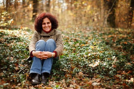 Portrait of a happy young woman outdoor in the forestの写真素材