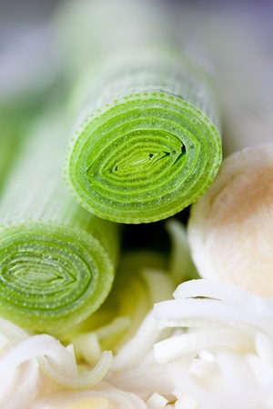 Closeup of a chopped leek on a wooden board in a kitchenの写真素材