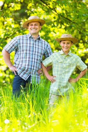 Father and son outdoor in an orchard, family conceptの写真素材