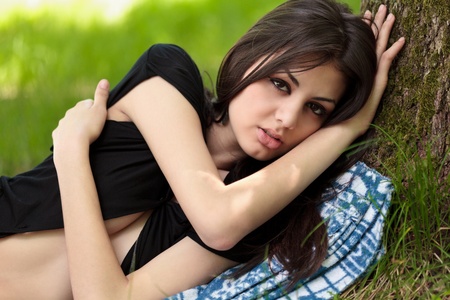 Portrait of a gorgeous sensual young woman outdoor in the forestの写真素材