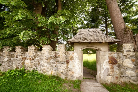 Stone gate, entrance in a medieval castle, with alleyの写真素材