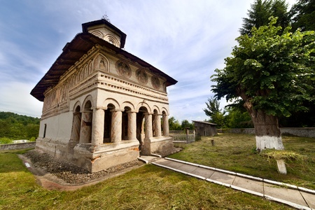 Landscape with a medieval church and a centenary linden tree nearbyの写真素材