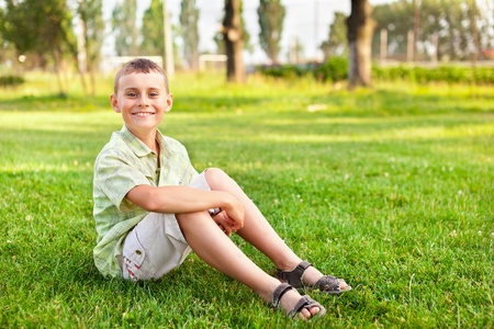 Portrait of a happy boy outdoor in a parkの写真素材