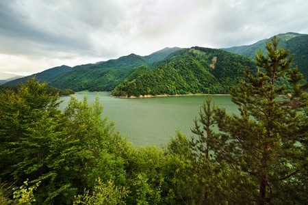 Landscape with lake in mountains in a cloudy dayの写真素材
