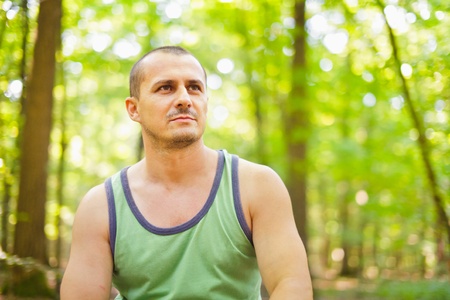 Closeup portrait of a fit young man outdoor in the forestの写真素材