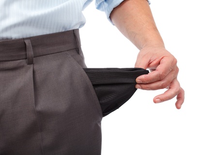 Businessman turning his empty pockets inside out, isolated on white backgroundの写真素材