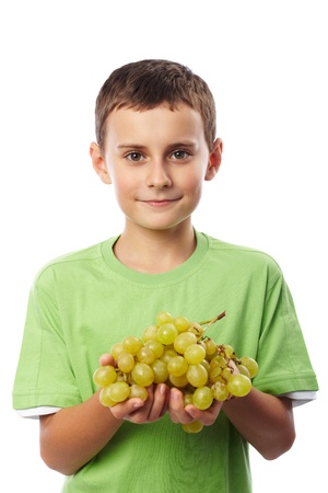 Boy with a cluster of ripe yellow grapes isolated on white backgroundの写真素材