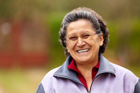 Closeup portrait of a cheerful grandma outdoor in the natureの写真素材