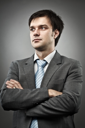 Studio portrait of a young businessman, with his arms foldedの写真素材