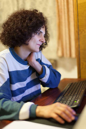 Closeup portrait of a woman at her computerの写真素材