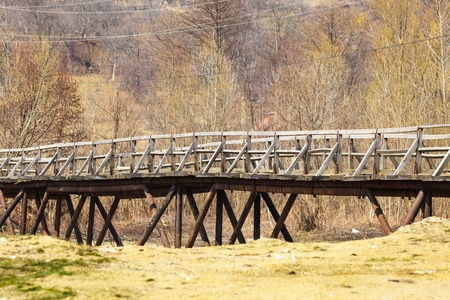 Old vintage wooden bridge over a creek in the countrysideの写真素材
