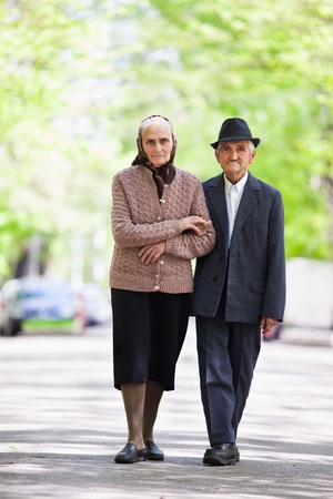 Senior couple walking outdoor in the parkの写真素材